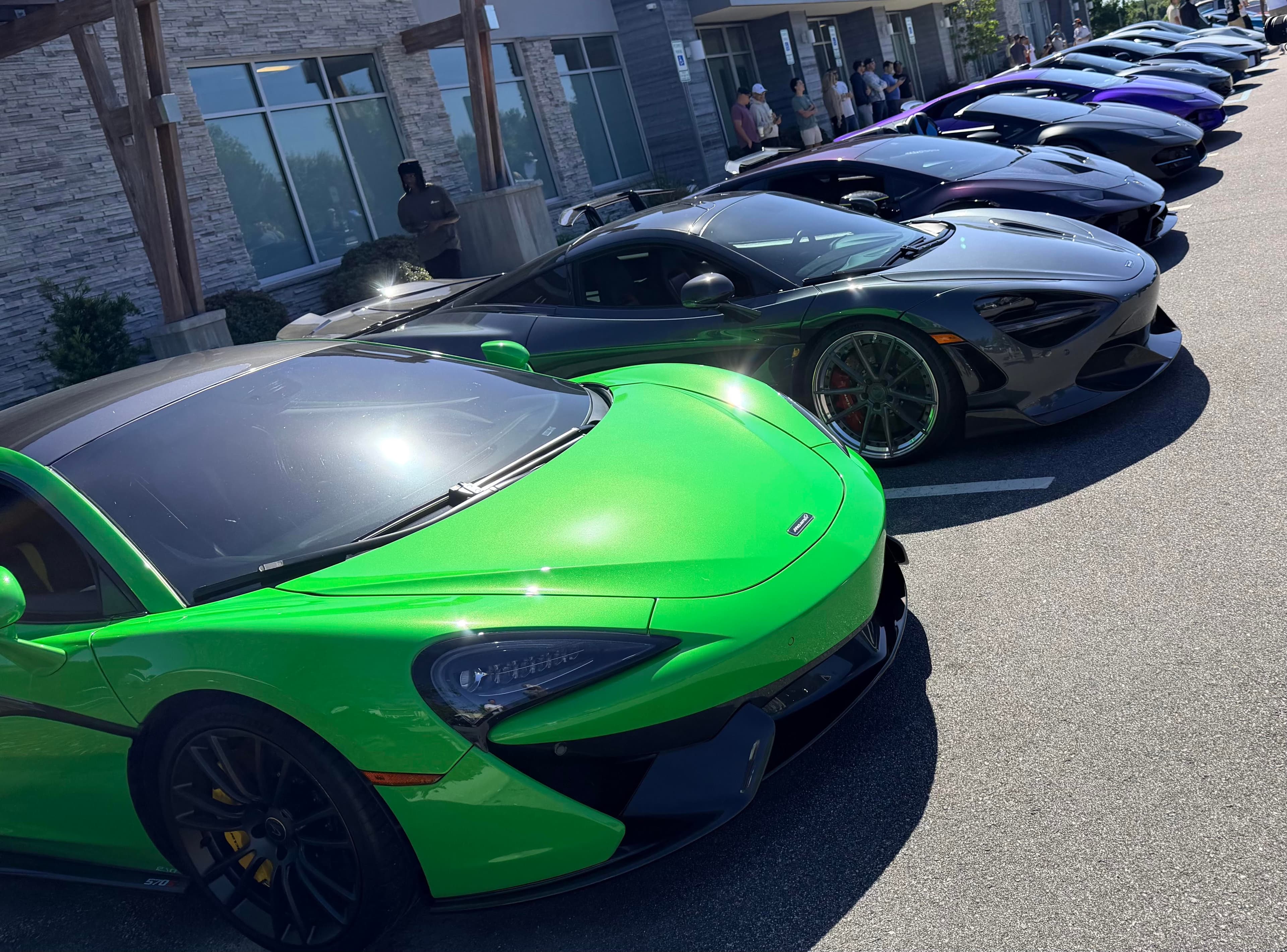 A green McLaren leading a lineup of exotic cars at a Hampton Roads Cars & Coffee gathering